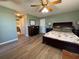 Comfortable main bedroom with hardwood floors and fan at 22941 Leafwood Ct, Land O Lakes, FL 34639