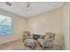 Bright sitting area with comfortable chairs and natural light from a large window at 2734 Silvermoss Dr, Wesley Chapel, FL 33544