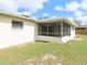 Rear exterior view of the house with a screen porch at 3094 Vernon Ter, Largo, FL 33770