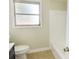 Bright bathroom featuring a toilet, shower, and window at 3094 Vernon Ter, Largo, FL 33770