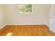 Sun-drenched bedroom featuring hardwood floors and a window view at 3094 Vernon Ter, Largo, FL 33770