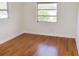 A sunlit bedroom features gleaming hardwood floors and neutral walls at 3094 Vernon Ter, Largo, FL 33770