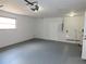 Clean garage with gray painted flooring, a window, and utility hookups at 3094 Vernon Ter, Largo, FL 33770