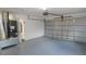 Spacious garage features a large garage door, painted floor, and utility connections at 3094 Vernon Ter, Largo, FL 33770