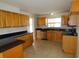 Spacious kitchen featuring tile floors, stainless steel dishwasher, and granite countertops at 3094 Vernon Ter, Largo, FL 33770