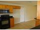Kitchen boasting wooden cabinets, granite countertops, and black appliances at 3094 Vernon Ter, Largo, FL 33770