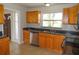 Kitchen area showing stainless steel dishwasher, granite countertops, and wooden cabinets at 3094 Vernon Ter, Largo, FL 33770