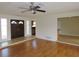 Bright living room with hardwood floors, ceiling fan, and a glimpse of the kitchen at 3094 Vernon Ter, Largo, FL 33770
