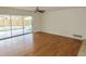 Spacious living room with hardwood floors, ceiling fan, and sliding glass doors at 3094 Vernon Ter, Largo, FL 33770