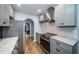 Well-lit kitchen featuring stainless steel appliances, gray cabinets, and hardwood floors at 315 Princess St, Clearwater, FL 33755