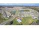 Wide aerial view of a residential community featuring multiple ponds, a playground and community swimming pool at 35542 Buttonweed, Zephyrhills, FL 33541