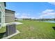 Expansive backyard featuring green lawn and a scenic view of the pond at 35542 Buttonweed, Zephyrhills, FL 33541
