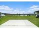 Backyard view featuring lush lawn and pond at 35542 Buttonweed, Zephyrhills, FL 33541