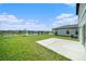 Spacious backyard with a serene water view, patio, and well-maintained lawn at 35542 Buttonweed, Zephyrhills, FL 33541