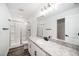 Clean and well-lit bathroom with a modern shower, granite countertops, and vanity at 35542 Buttonweed, Zephyrhills, FL 33541