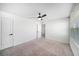 Bright bedroom with plush carpet, ceiling fan, and natural light at 35542 Buttonweed, Zephyrhills, FL 33541