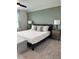 Serene main bedroom with a comfortable bed, stylish bench, and soothing color palette, creating a relaxing retreat at 35542 Buttonweed, Zephyrhills, FL 33541