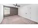 Bedroom with plush carpet, accent wall, and natural light at 35542 Buttonweed, Zephyrhills, FL 33541