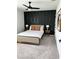 Modern bedroom with a striking black accent wall and stylish decor, creating a sophisticated and inviting space at 35542 Buttonweed, Zephyrhills, FL 33541