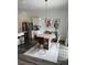 Bright dining area features a modern chandelier, seating for four, and stylish decor at 35542 Buttonweed, Zephyrhills, FL 33541