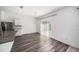 Bright dining room with modern light fixture, hardwood floors, and a sliding glass door to the backyard at 35542 Buttonweed, Zephyrhills, FL 33541
