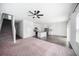 Open-concept kitchen and living area with modern appliances, granite countertops, and a staircase at 35542 Buttonweed, Zephyrhills, FL 33541