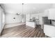 Bright, open-concept living space with modern kitchen featuring stainless steel appliances and granite countertops at 35542 Buttonweed, Zephyrhills, FL 33541
