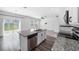 Bright, airy kitchen featuring a granite island, stainless steel appliances, and sliding glass doors to the backyard at 35542 Buttonweed, Zephyrhills, FL 33541