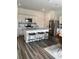 Modern kitchen featuring white cabinets, stainless steel appliances, granite countertops, and a stylish backsplash at 35542 Buttonweed, Zephyrhills, FL 33541