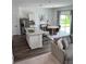 Open-concept kitchen with island sink, stainless steel appliances, white cabinets, and breakfast bar at 35542 Buttonweed, Zephyrhills, FL 33541