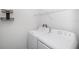 Laundry room featuring new white washer and dryer at 35542 Buttonweed, Zephyrhills, FL 33541