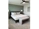 Serene main bedroom with a comfortable bed, stylish bench, and soothing color palette, creating a relaxing retreat at 35542 Buttonweed, Zephyrhills, FL 33541