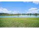 Tranquil water view with lush green lawn, perfect for enjoying nature at 35542 Buttonweed, Zephyrhills, FL 33541