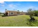 Backyard with sunny lawn, partial fence, and neutral-toned exterior at 3639 Richboro Dr, Holiday, FL 34691