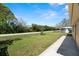 Well-maintained backyard provides greenery and privacy with a view of the road at 3639 Richboro Dr, Holiday, FL 34691