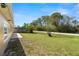 Spacious backyard offers green lawn, partial fence, and serene surroundings at 3639 Richboro Dr, Holiday, FL 34691