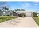 This charming single-Gathering home features a well-manicured lawn, a stone accent wall, and neutral paint at 3639 Richboro Dr, Holiday, FL 34691