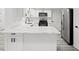 Modern white kitchen features stainless steel appliances, quartz counters, and custom cabinets at 3639 Richboro Dr, Holiday, FL 34691
