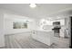 Modern kitchen with white cabinets, stainless steel appliances, and an open floor plan at 3639 Richboro Dr, Holiday, FL 34691