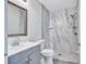 Updated bathroom features marble-look shower and gray vanity with modern faucet at 4106 Waterside Island Ct, Tampa, FL 33617