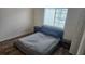 Bedroom featuring wood-look flooring and a window letting in natural light at 4106 Waterside Island Ct, Tampa, FL 33617