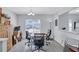 Bright dining area with large window, tile floor and a chandelier over a wood table at 4106 Waterside Island Ct, Tampa, FL 33617