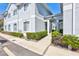 Light gray two-story condo with manicured bushes near the walkway to the main entrance at 4106 Waterside Island Ct, Tampa, FL 33617