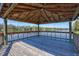 Lakeside gazebo featuring a wooden deck, railing, and a beautiful view of the water at 4106 Waterside Island Ct, Tampa, FL 33617