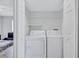 Laundry room area features washer and dryer hookups and shelving for storage at 4106 Waterside Island Ct, Tampa, FL 33617
