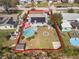 A high aerial view of the property and surrounding area featuring a swimming pool, fire pit, and solar panels at 4346 10Th N Ave, St Petersburg, FL 33713