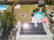 Aerial view of the backyard featuring a solar panel roof, in-ground pool, above ground pool and fire pit at 4346 10Th N Ave, St Petersburg, FL 33713