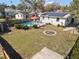 Aerial view of the fenced backyard with a pool, firepit, shed, and ample grass at 4346 10Th N Ave, St Petersburg, FL 33713