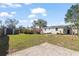 Large backyard with a fire pit, shed, and well-manicured lawn at 4346 10Th N Ave, St Petersburg, FL 33713