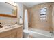 Cozy bathroom with shower and tub, and a wood-framed mirror at 4346 10Th N Ave, St Petersburg, FL 33713